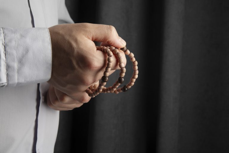 still life crucifix held hand