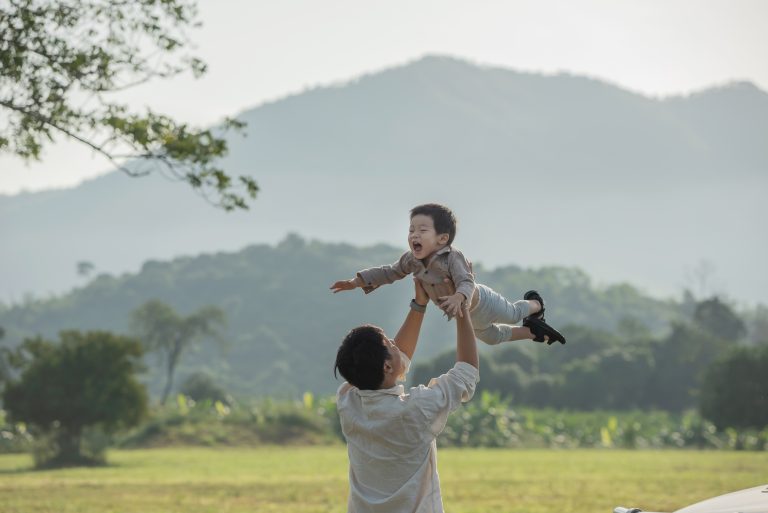 father son playing park sunset time people having fun field concept friendly family summer vacation 1 1