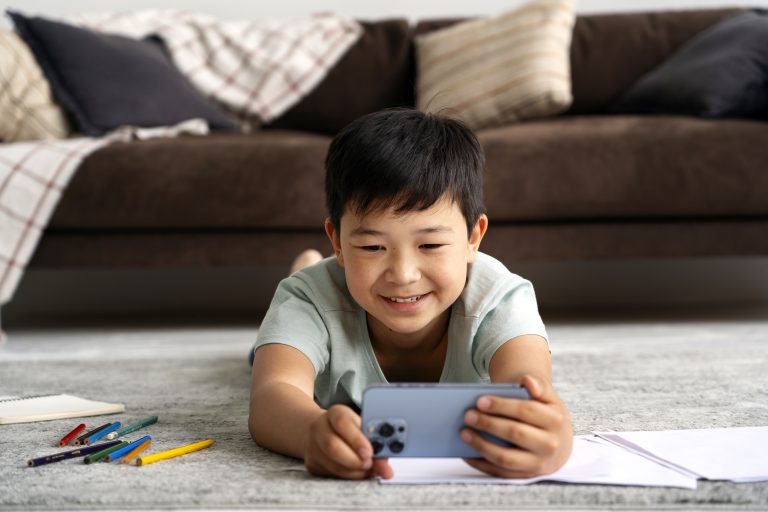 full shot smiley kid taking selfie